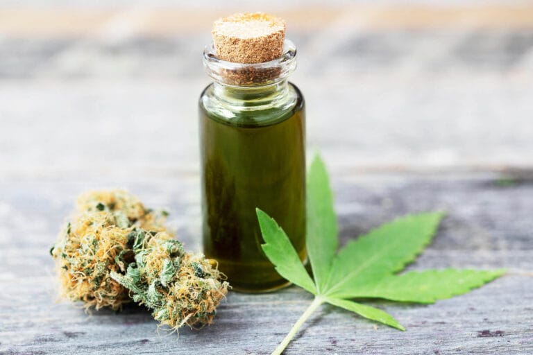 Bottle of cannabis oil with cannabis bud